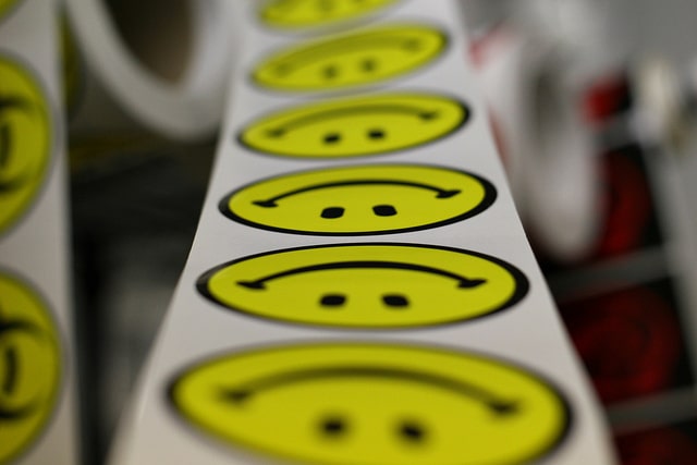 a lengthy sticker printer with smiley faces