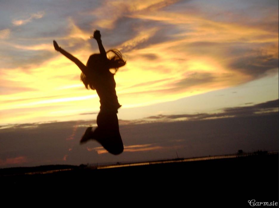 You can change your life for the better using the power of positivity. Photo of woman jumping for joy at sunrise.