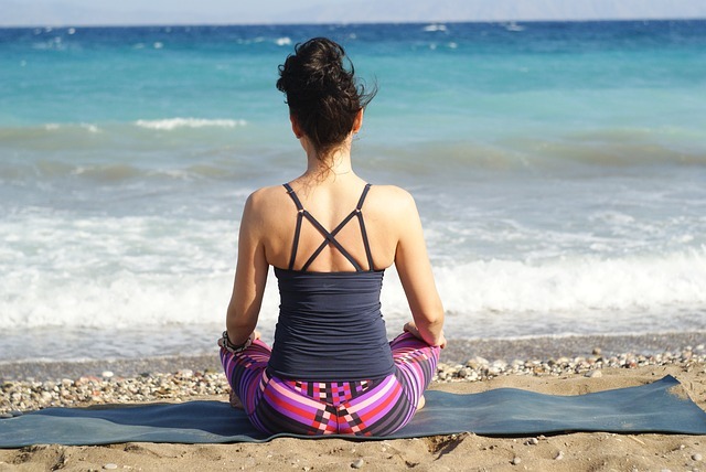 a woman meditating on a beach, one of the brain tricks